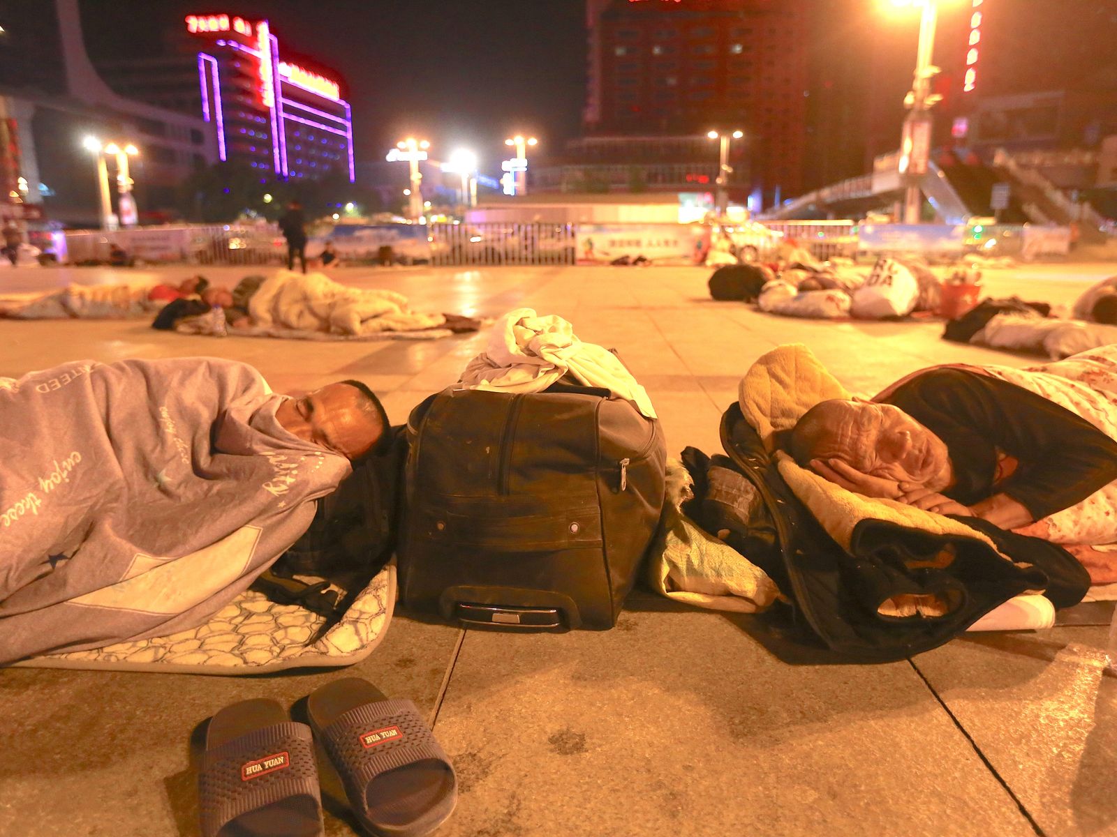 People sleeping at Zhengzhou Railway Station Square