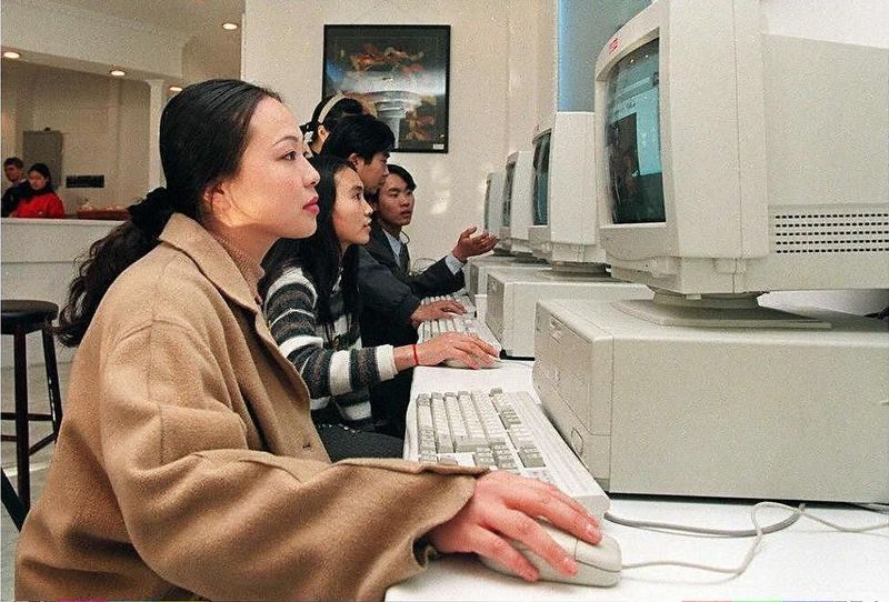 Customers browsing the internet at an internet cafe in Beijing 1996, remembering China’s internet cafes