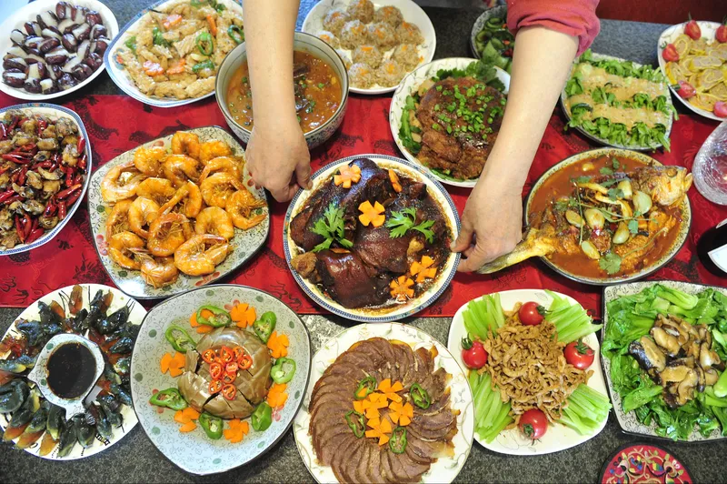 A Chinese New Year’s Eve dinner (年夜饭) spread containing fish