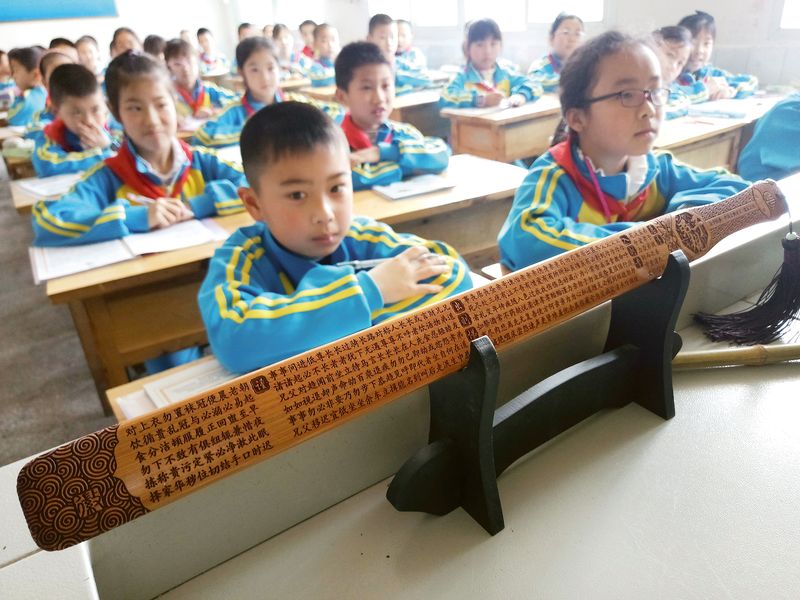 Jiechi, wooden rods historically used for discipline in Confucian academies, are placed in an elementary school classroom in Sichuan, corporal punishment in Chinese families