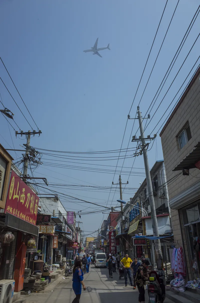 Picun Village, located under the flight path of Beijing's Capital International Airport, attracts many migrant workers due to its cheap rental prices