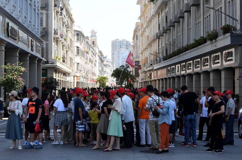 Chinese tourists following a tour guide in Xiamen, Fujian province