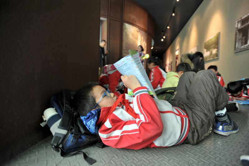 Young Chinese student completing homework 