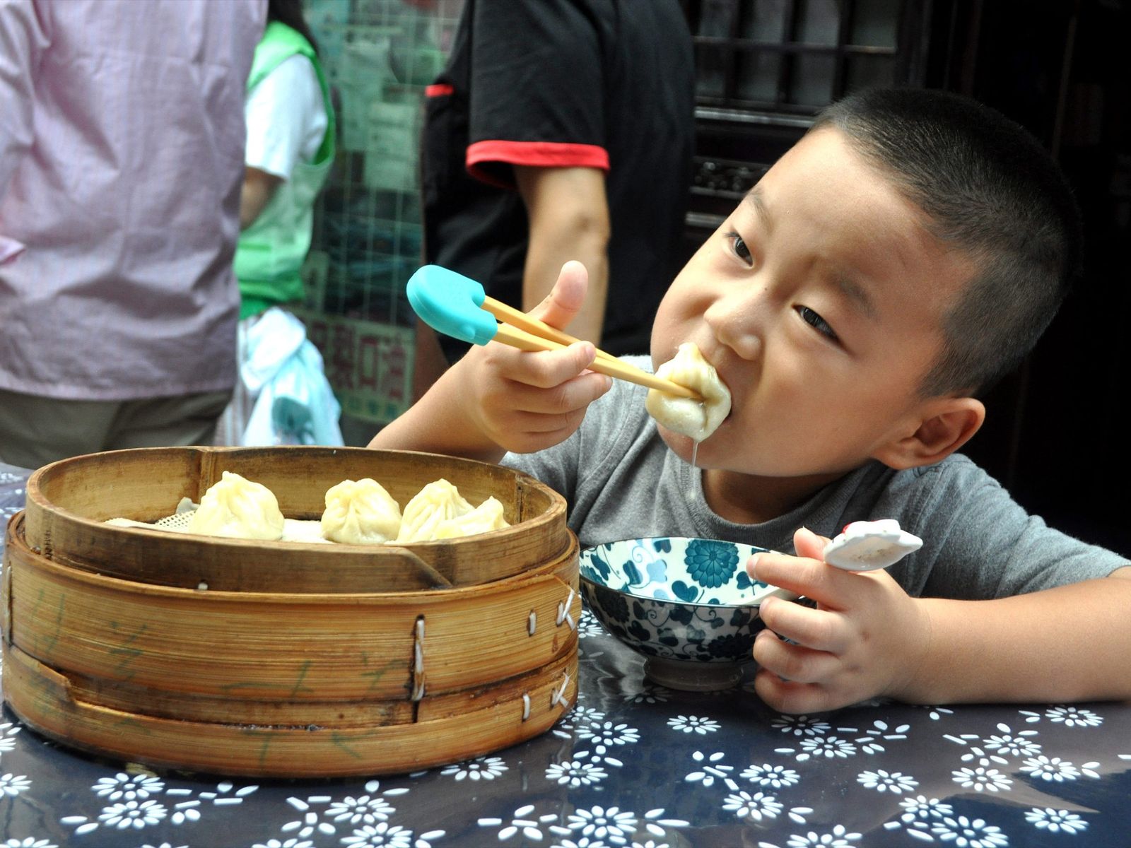 Boy eating xiao long bao