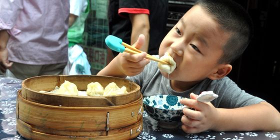 Boy eating xiao long bao