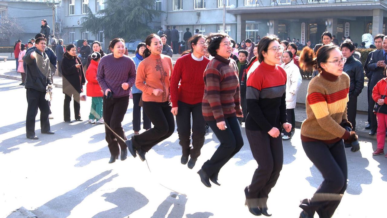 Companies often arrange creative ways to celebrate the day. For female employees of this water bureau office in Henan province in 2002, this involved skipping in a playground, aided by male employees