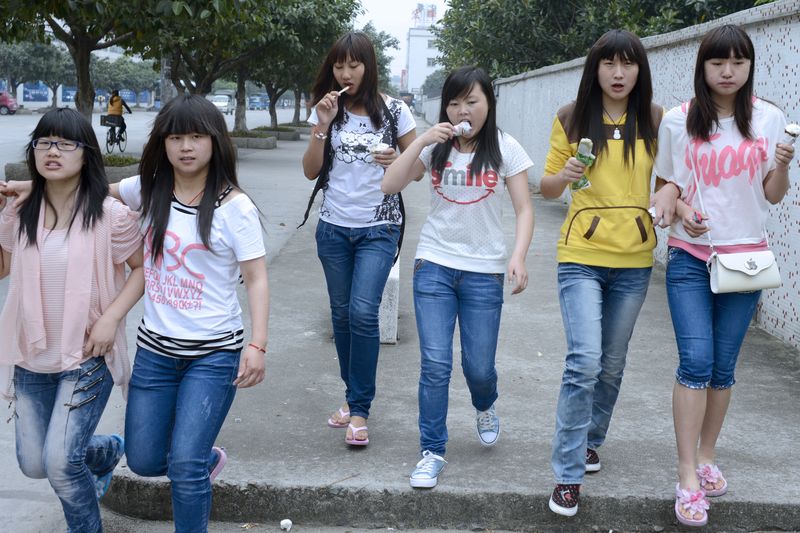 Young female workers in Dongguan socializing after work in 2013.