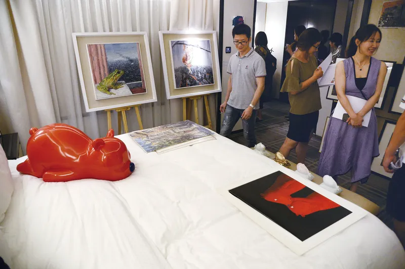 Young visitors browsing the exhibits during the 2019 Art Fair in Hotel (AFIH) in the suites of the Peninsula Beijing