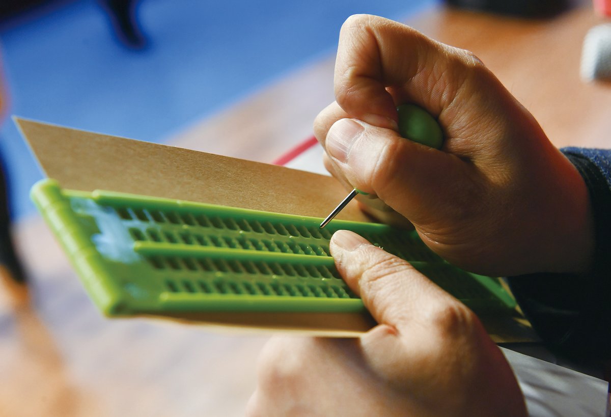 A slate and stylus used for producing braille, visually impaired in China