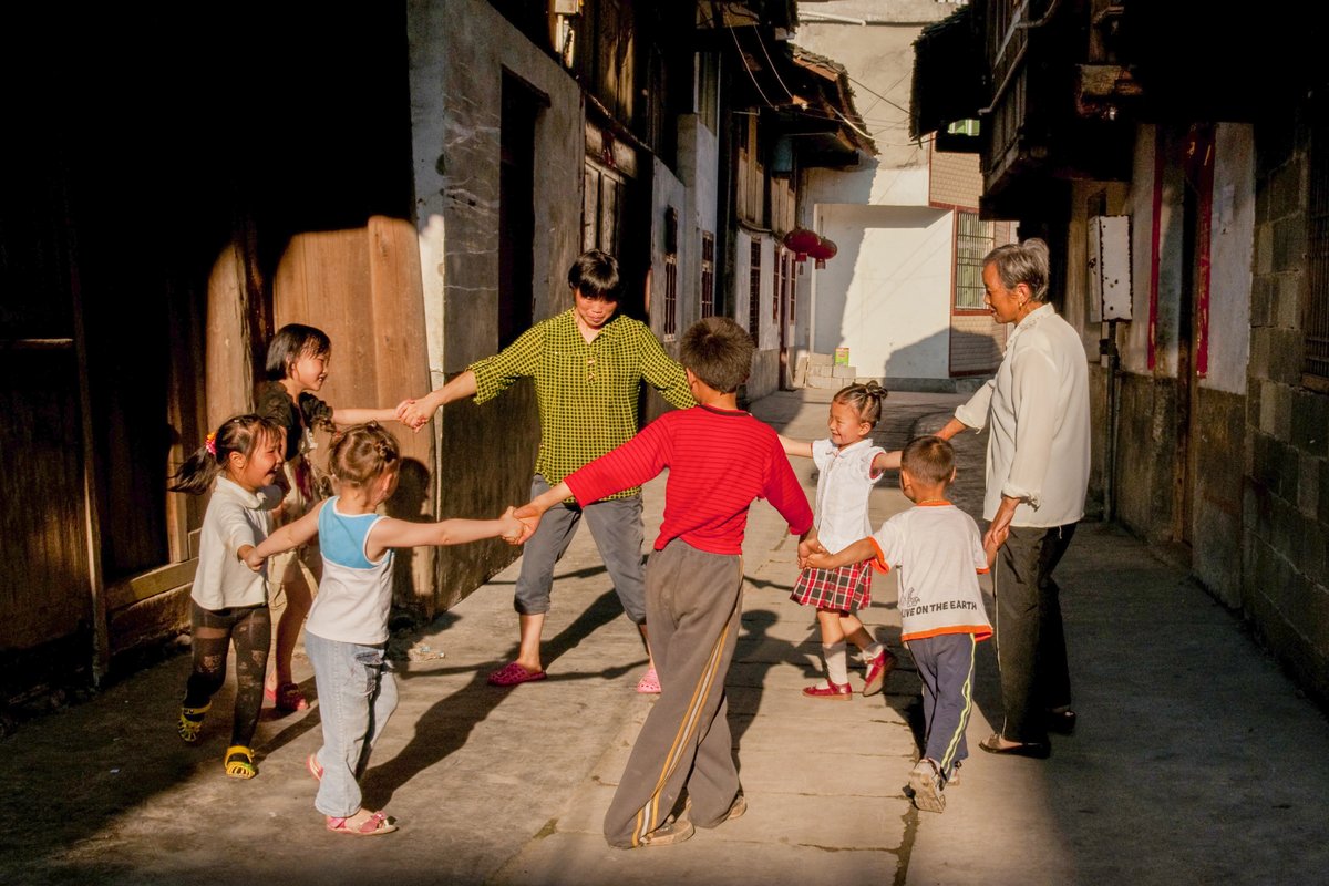 Kids are playing traditional games with their grandparents