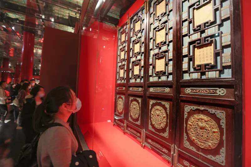 Tourists viewing screens at an exhibit in the Palace Museum in Beijing in 2020