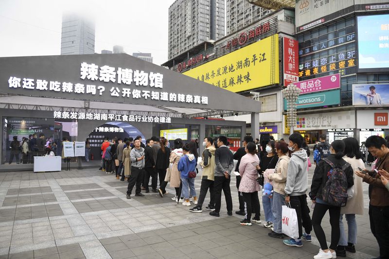 The slogan “Do you still dare eat latiao? sits atop the entrance of the Latiao Museum in Changsha, Hunan as people line up to enter