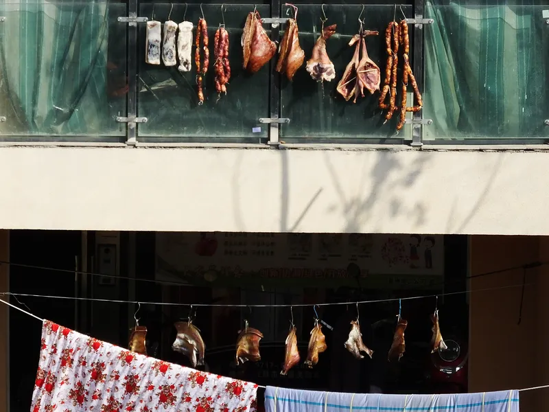 Sausages and various larou hung outside a residential building in Yichang, Hubei province