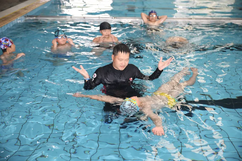 Students learning to swim in a pool