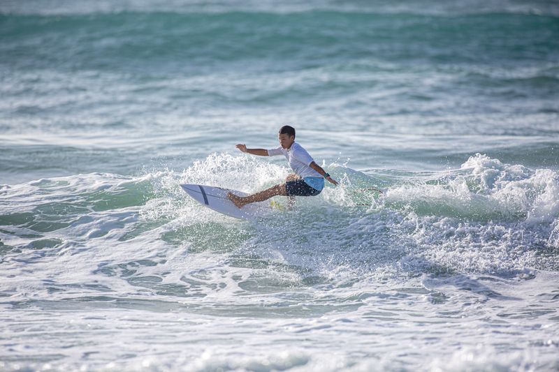 Chinese surfer Yang Siqi competing in a surfing event in Hainan, will also compete in the 2024 Paris Olympics