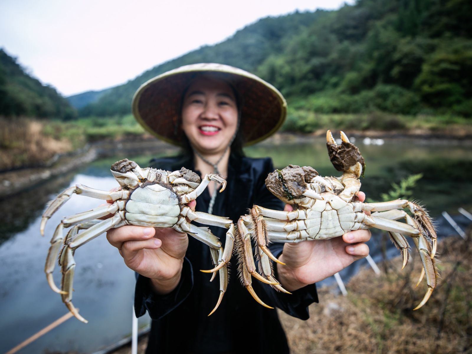 Woman holding two crabs