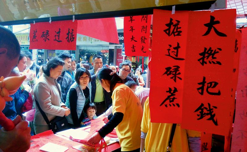 Visitors flock to a stall selling Cantonese New Year calligraphy
