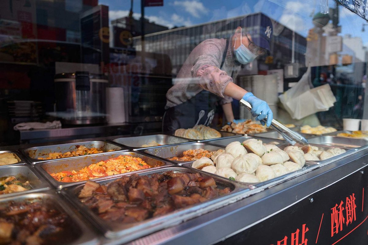 A vendor offering baos and other Chinese foods at a restaurant in Queens, New York City