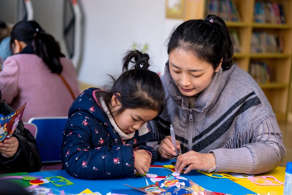 Mother and daughter working on crafts together