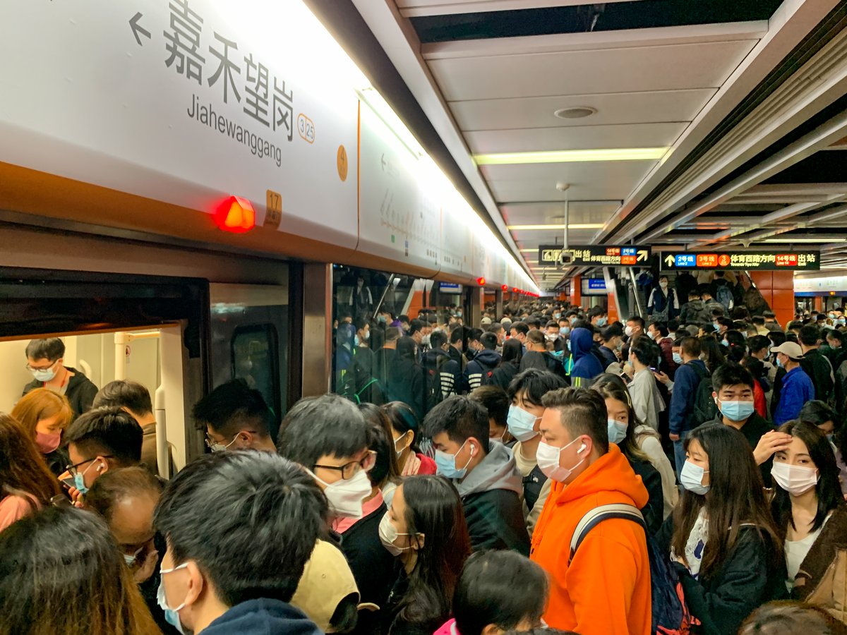 Commuters in a Guangzhou subway are busy with long commutes, Chinese urban sprawl