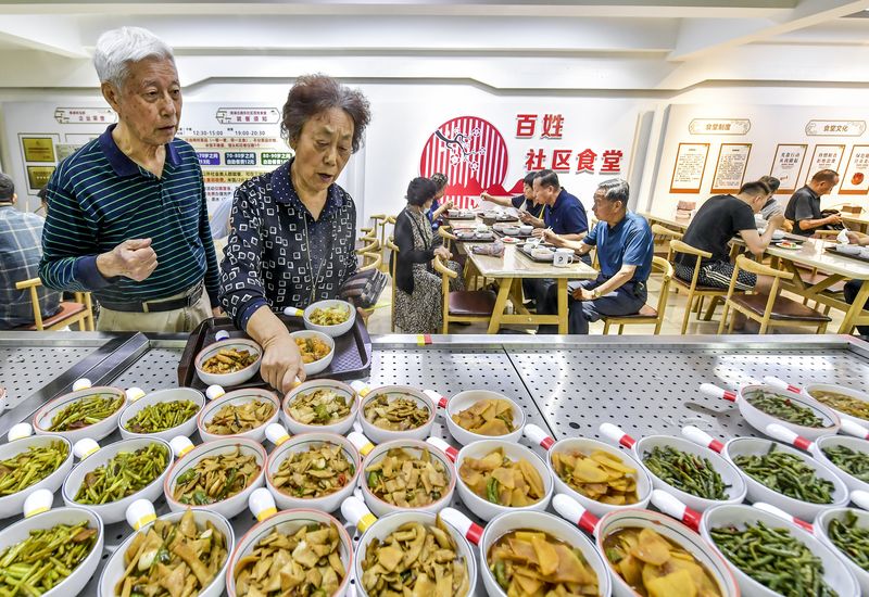 elders ordering dishes in a community canteen