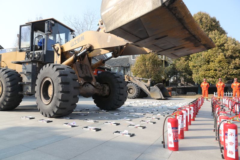 A bulldozer in Shandong province drives over fake fire prevention products as officials and firefighters watch on, China’s Consumer Rights Gala