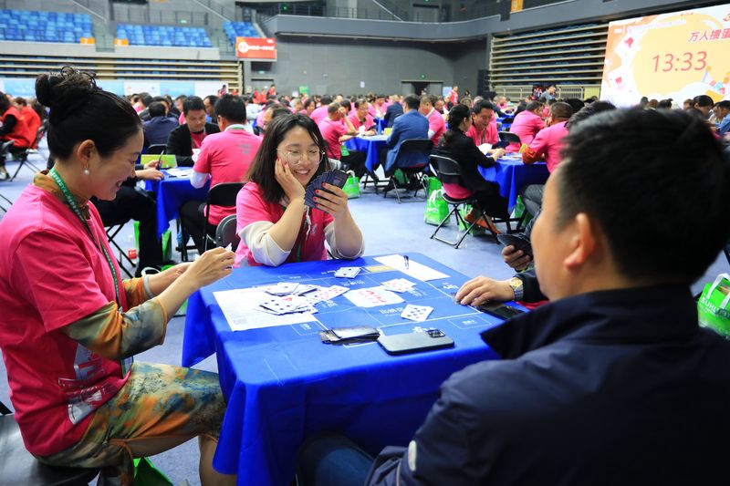 Contestants participating in a guandan competition in Huai’an Sports Center, China card game