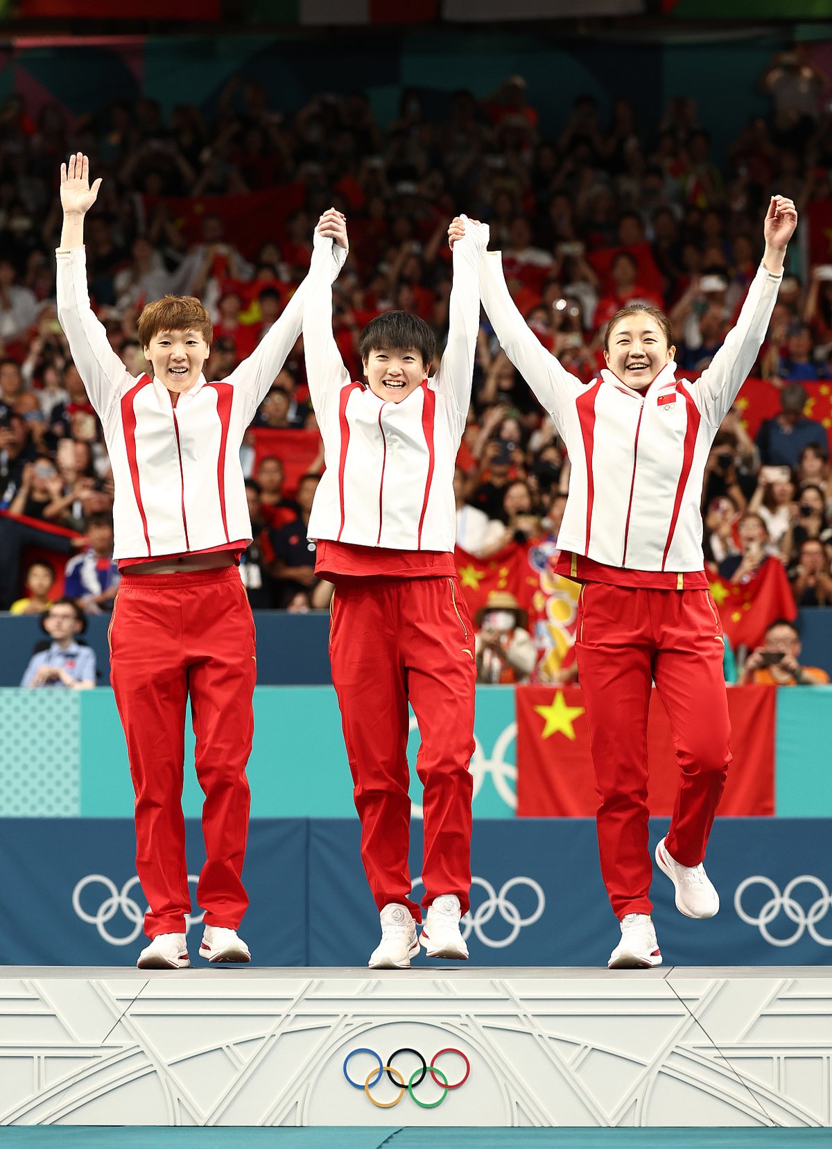 Wang Manyu, Sun Yingsha, and Chen Meng celebrating after receiving gold medals in Pingpong in Paris olympic 2024