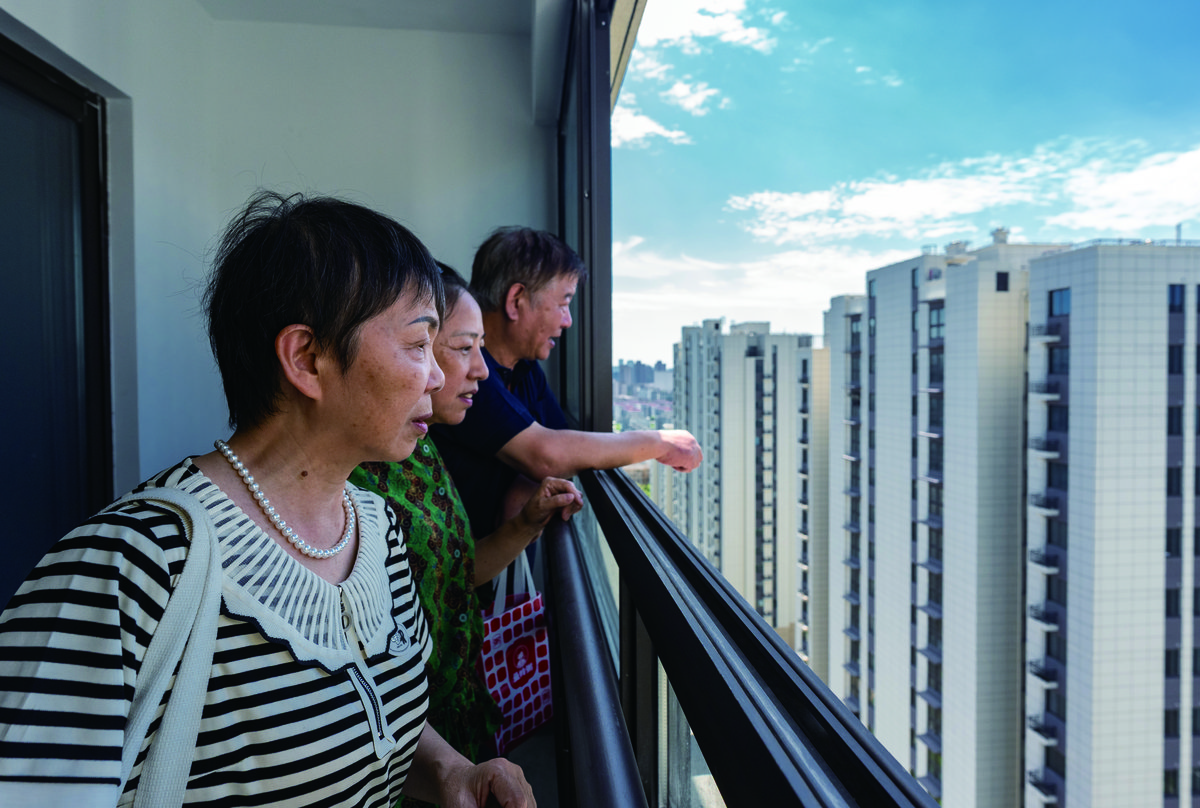 Residents who previously lived in the 1950s residential area inspect their new apartments built on the same site in Shanghai’s Pengyi Compound