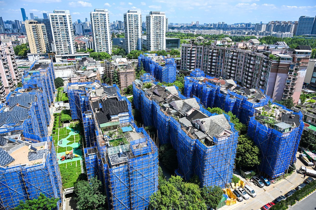 An old residential compound in Nanjing, Jiangsu, is undergoing large-scale renovations—including new elevators and façade upgrades—to improve living conditions, though the work inevitably disrupts res
