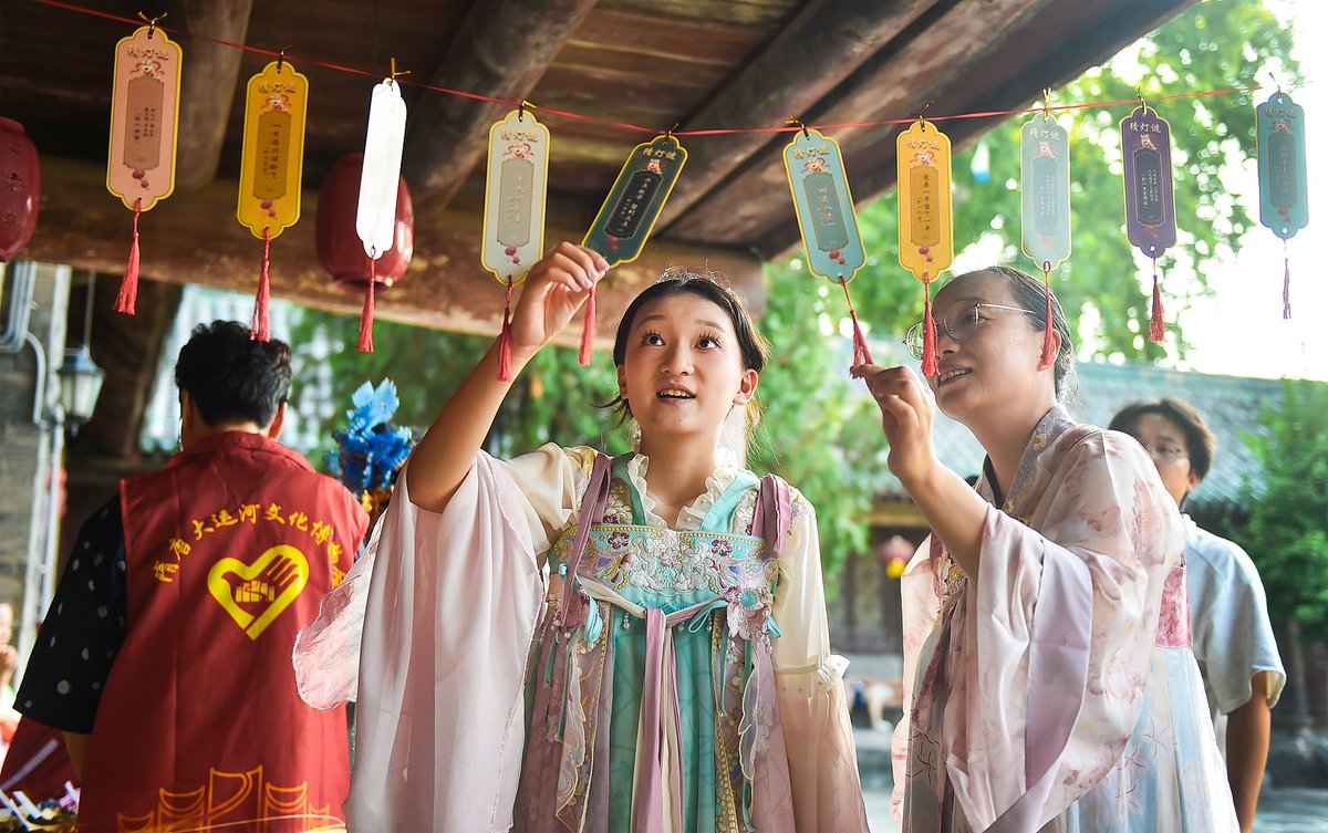 a group of girls solves lantern riddles to celebrate Qixi, Qixi celebration in Henan China