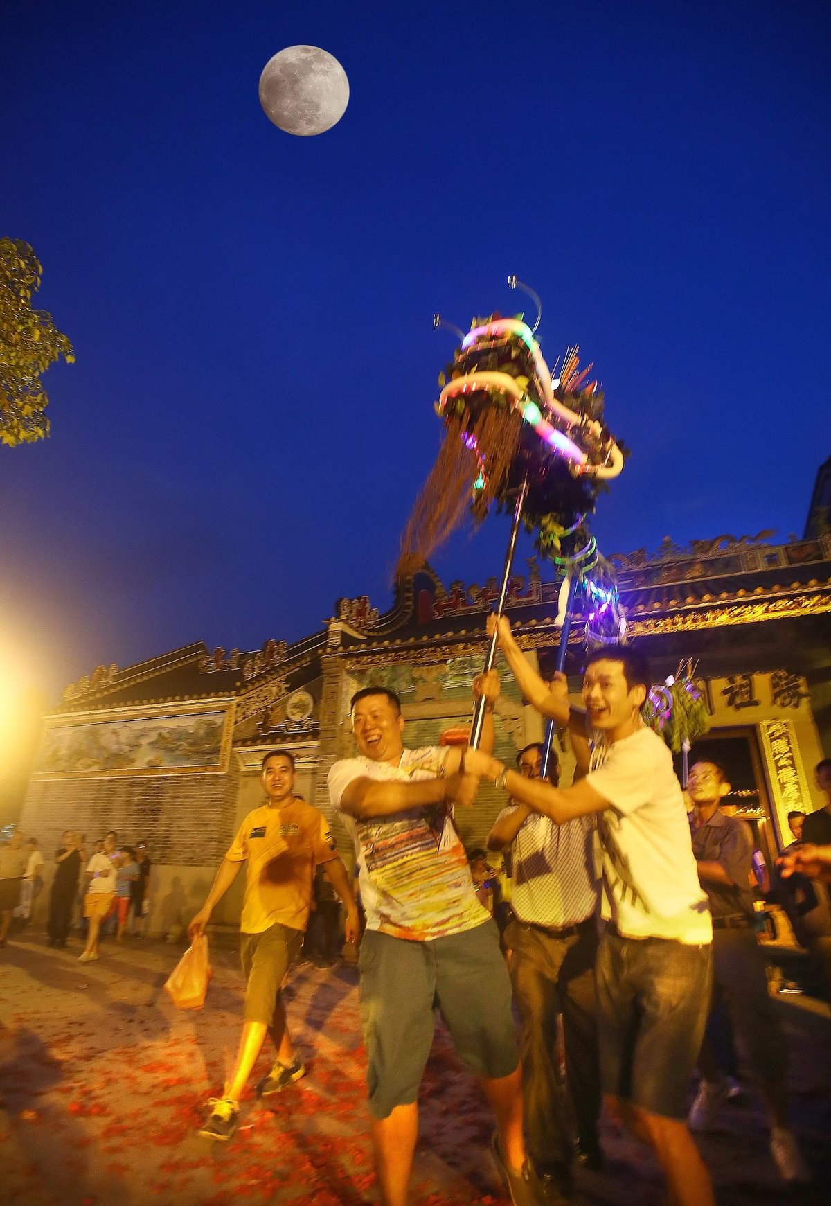 Locals perform the “fire dragon dance,” a Mid-Autumn Festival custom in Xiamao village, Guangdong province, in 2014
