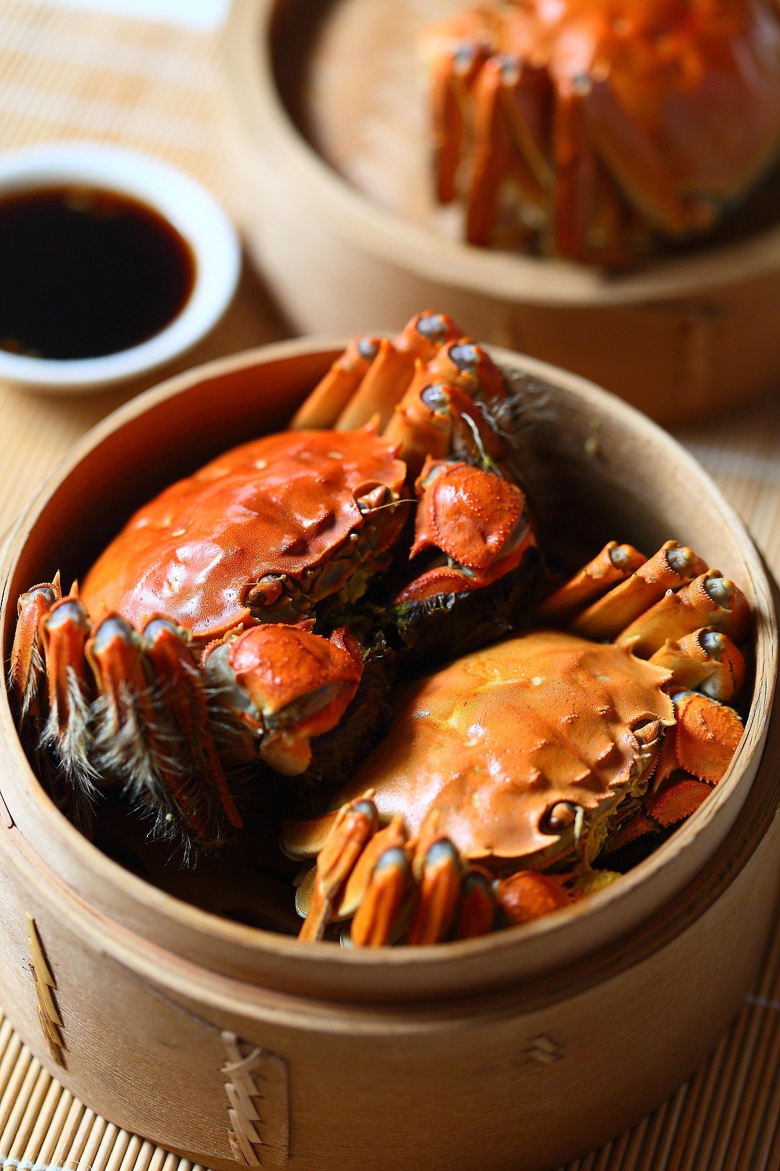 The steamed crabs are often enjoyed with yellow rice wine or a special vinegar specifically paired with the dish