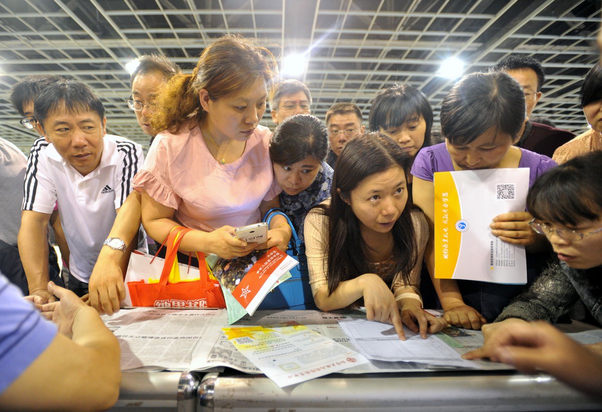 Chinese parents speak with admissions counselors at a College Admissions Exhibition in Nanjing, Jiangsu province