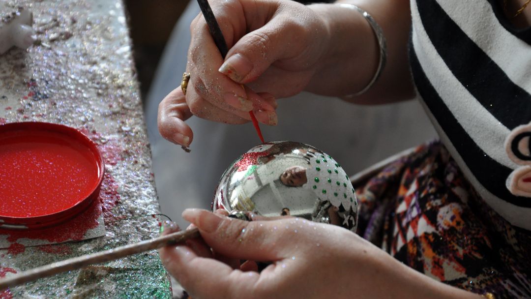 Factory worker making Christmas ornaments in China
