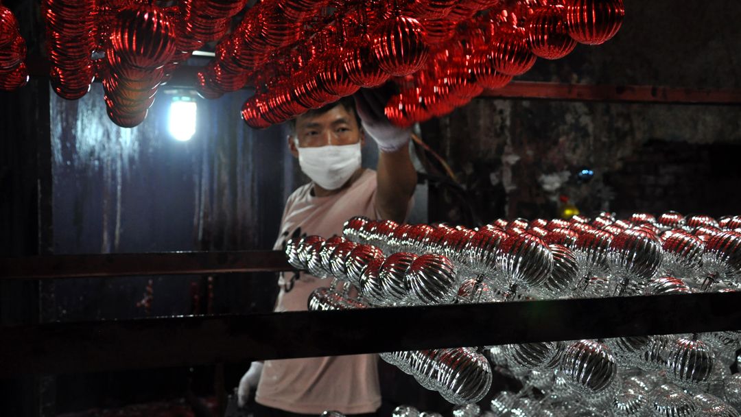 Chinese factory worker making Christmas decorations