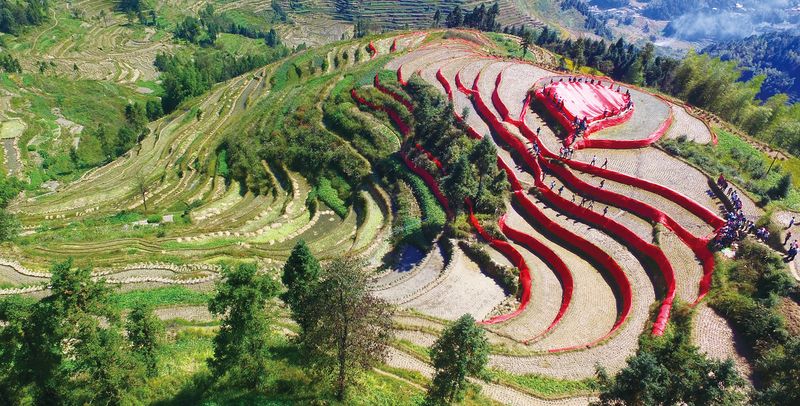 A group of artists wrapped red cloth over the Ziquejie rice terraces in “Land’s Pulse,” part of an art festival in Hunan province in 2015