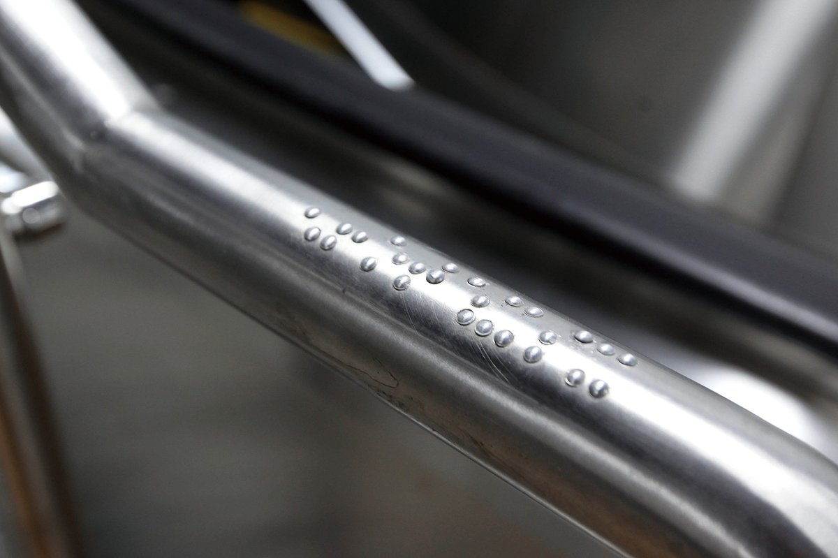 Braille on a handrail in a subway station