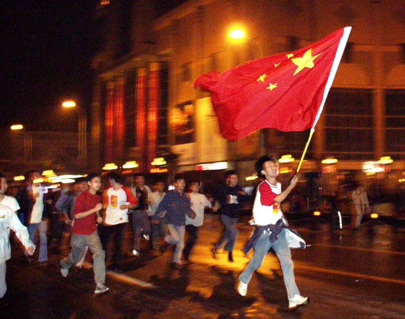 Fans in Wuhan take to the streets in celebration after China won its match against Oman and secured qualification to the World Cup