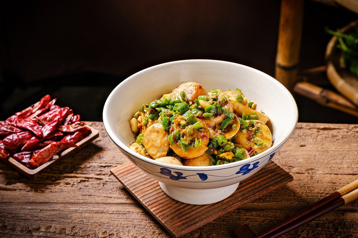 A specialty from Hengyang, Hunan, Hengdong roasted eggs are first roasted over a wood fire, then sliced and stir-fried with green chili peppers and spices, creating a smoky, fiery dish