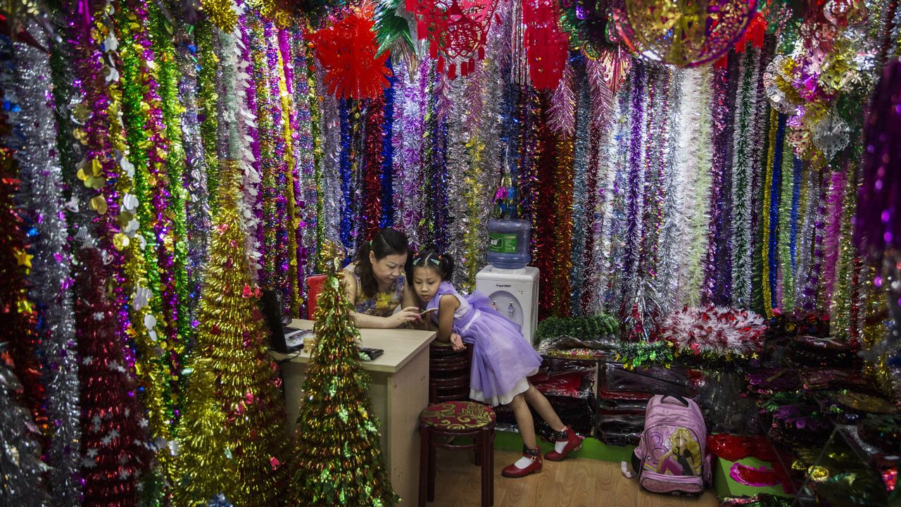 Shopkeepers at Christmas stall at Yiwu Trade Fair, China