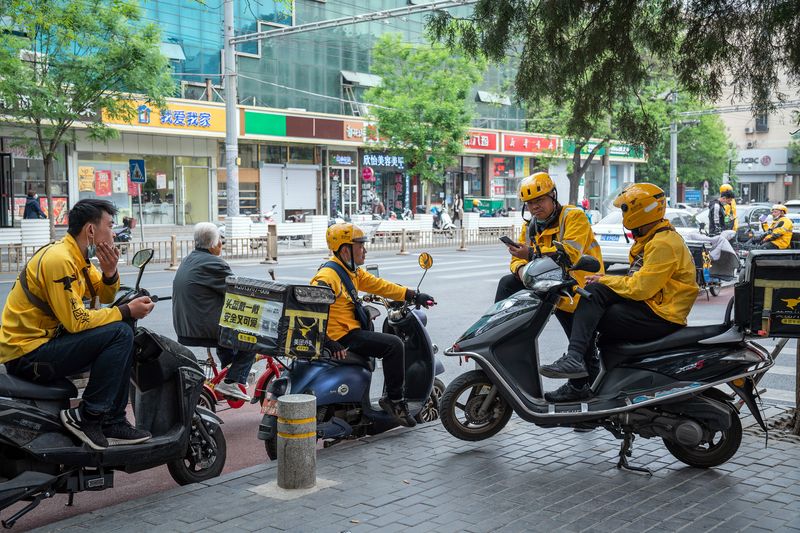 Couriers waiting for orders by the street