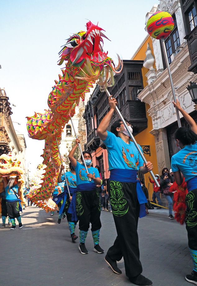 The Chinese Charity Society performs a dragon dance in the streets of Lima, celebrating the 72nd anniversary of the PRC in 2021