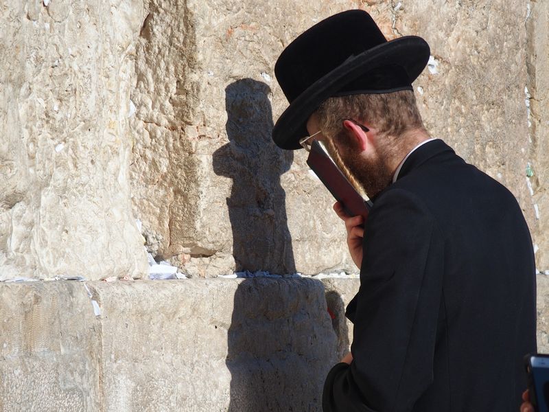 A Jewish man praying at the Western Wall in the Old City of Jerusalem