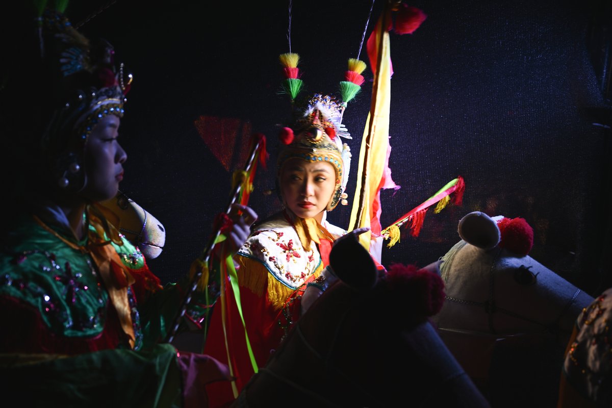 Performers from the Xiaxi Cloth-horse Dance Troupe wait backstage to participate in the Spring Festival gala
