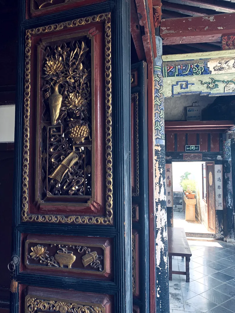 Intricate floral designs and symbols are carved into many of the doorways of the Zhu Family Garden