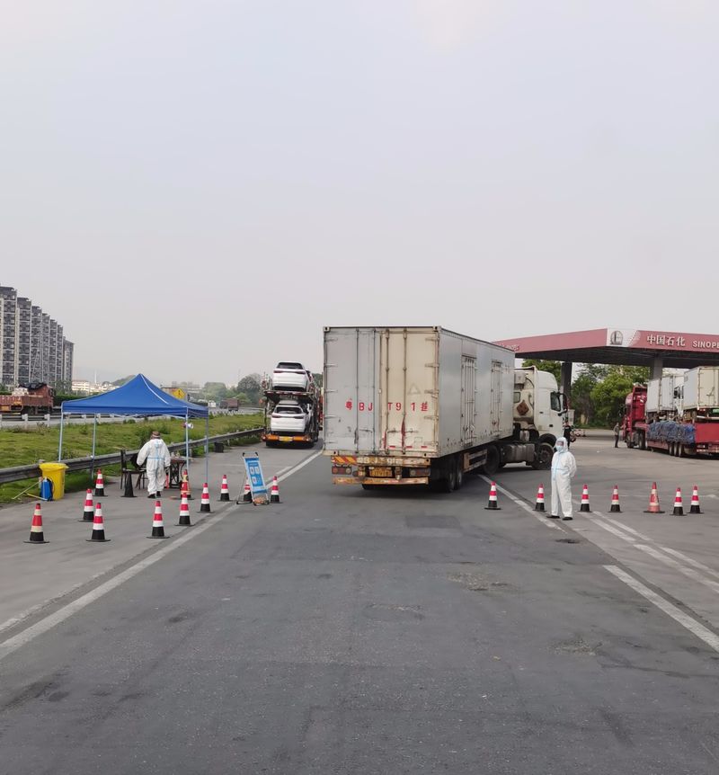 Epidemic prevention workers wait at an inspection checkpoint in Nanchang