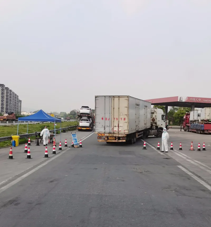 Epidemic prevention workers wait at an inspection checkpoint in Nanchang