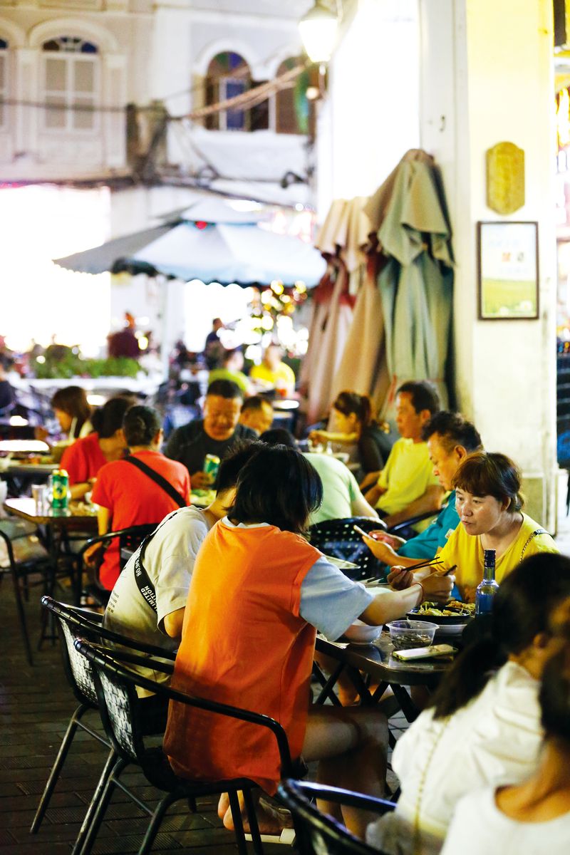 Locals and tourists dining outdoors in Haikou’s Historic Qilou Streets area