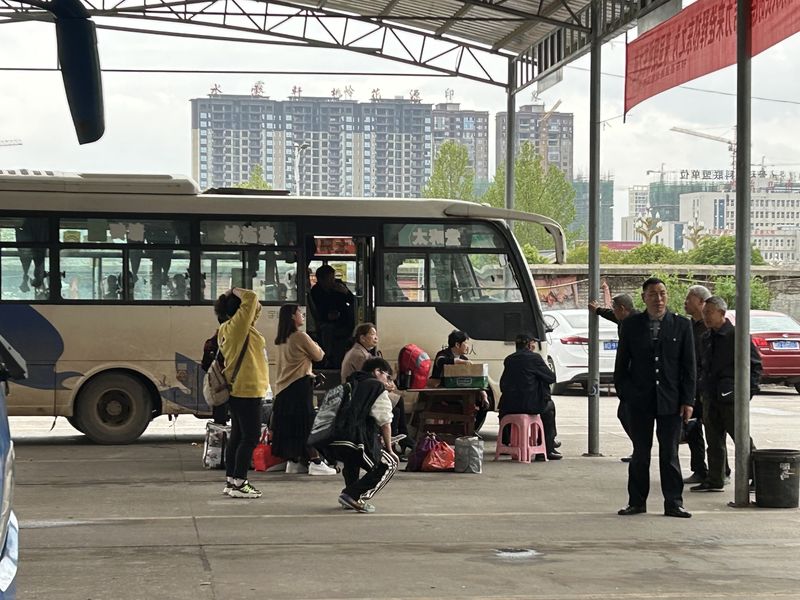 Passengers waiting to board an intercity coach in central China, Hunan province